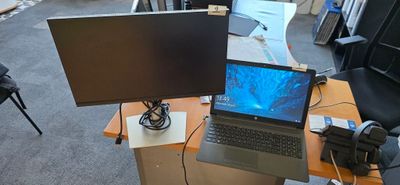 a desk with a laptop and a monitor on it