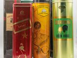 many different types of liquor in tins on a table