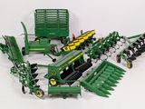a lot of toy farm equipment on a white surface