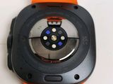 a close up of a watch on a white surface