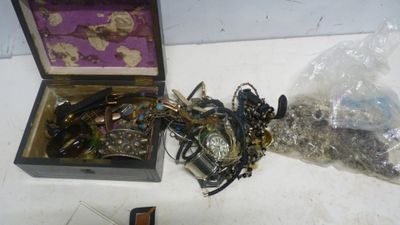 une boîte à bijoux posée sur une table à côté d'un téléphone portable