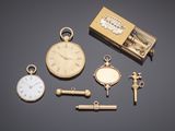 an image of a group of watches and a key on a table