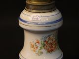 a white and blue vase with flowers on it