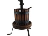 an old fashioned wooden wine press with a metal stand