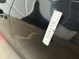 a sticker on the door of a black car