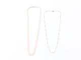 two necklaces on a white surface with a white background