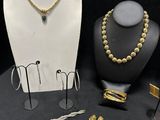a lot of jewelry on display on a black table