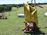 a yellow cloth on the back of a tractor in a field