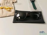a pair of sunglasses and a watch sitting on a table
