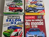 four magazine covers of different cars on display on a table