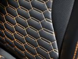 a close up of a seat in a car with gold stitching on it
