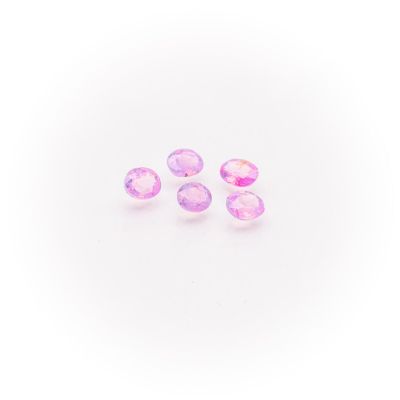 a group of three pink sapphires on a white background