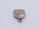 an image of a silver and gold ring with diamonds on a white surface