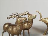 two bronze deer statues that are standing next to each other