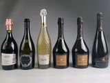 several bottles of wine are lined up in a row on a table