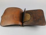 an old leather wallet is open on a white surface