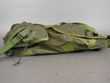 a large green bag that is laying on the ground