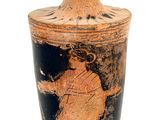 a black and brown vase sitting on a white surface