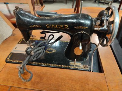 a black sewing machine sitting on a table in a room