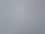 a snowboarder that is going down the hill in the snow
