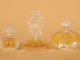 three perfume bottles sitting next to each other on a table