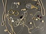 several different types of jewelry are arranged on a table