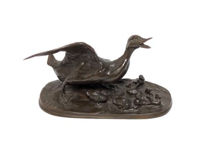 bronze sculpture of a bird on a rock with a white background