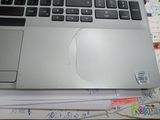 a laptop computer sitting on top of a pile of papers