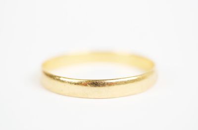a close up of a gold ring on a white surface