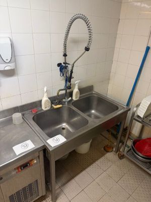 two sinks in the kitchen with a faucet and a sink