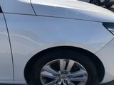 a white car parked in a parking lot with other cars in the background