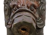 a close up of a fire hydrant with a dog ' s face on it