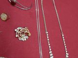a lot of jewelry on a red table