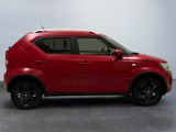 the red car is parked on the concrete floor in the room