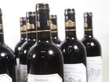 several bottles of wine are lined up on a table