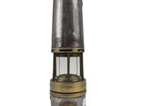 an old fashioned metal and glass lantern on a white background