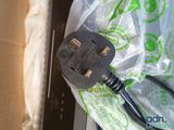 a black power cord plugged into a plastic bag