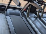 a treadmill with a monitor on top of it