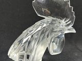 clear glass rooster figurine on a black background