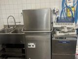 a kitchen with a sink, dishwasher, and other items in it