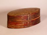 a small wooden box with a lid on a white surface