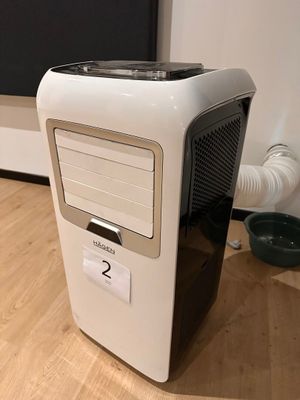 a small computer on the floor in front of a tv