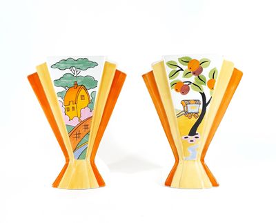 two vases that have been painted with oranges on them