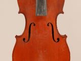 an old violin sitting on top of a white surface