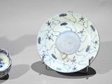 a blue and white plate and a bowl on a table