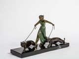 bronze statue of a woman with two dogs and a cat on a marble base
