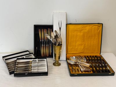 a lot of silverware in a case on a table
