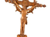 an antique wooden crucifix with a cross on a stand