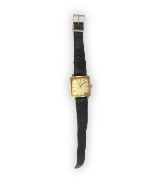 an image of a gold plated wrist watch with a black leather strap