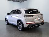 the rear end of a silver suv parked in a garage